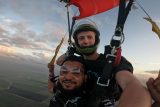 Male tandem skydiver under canopy