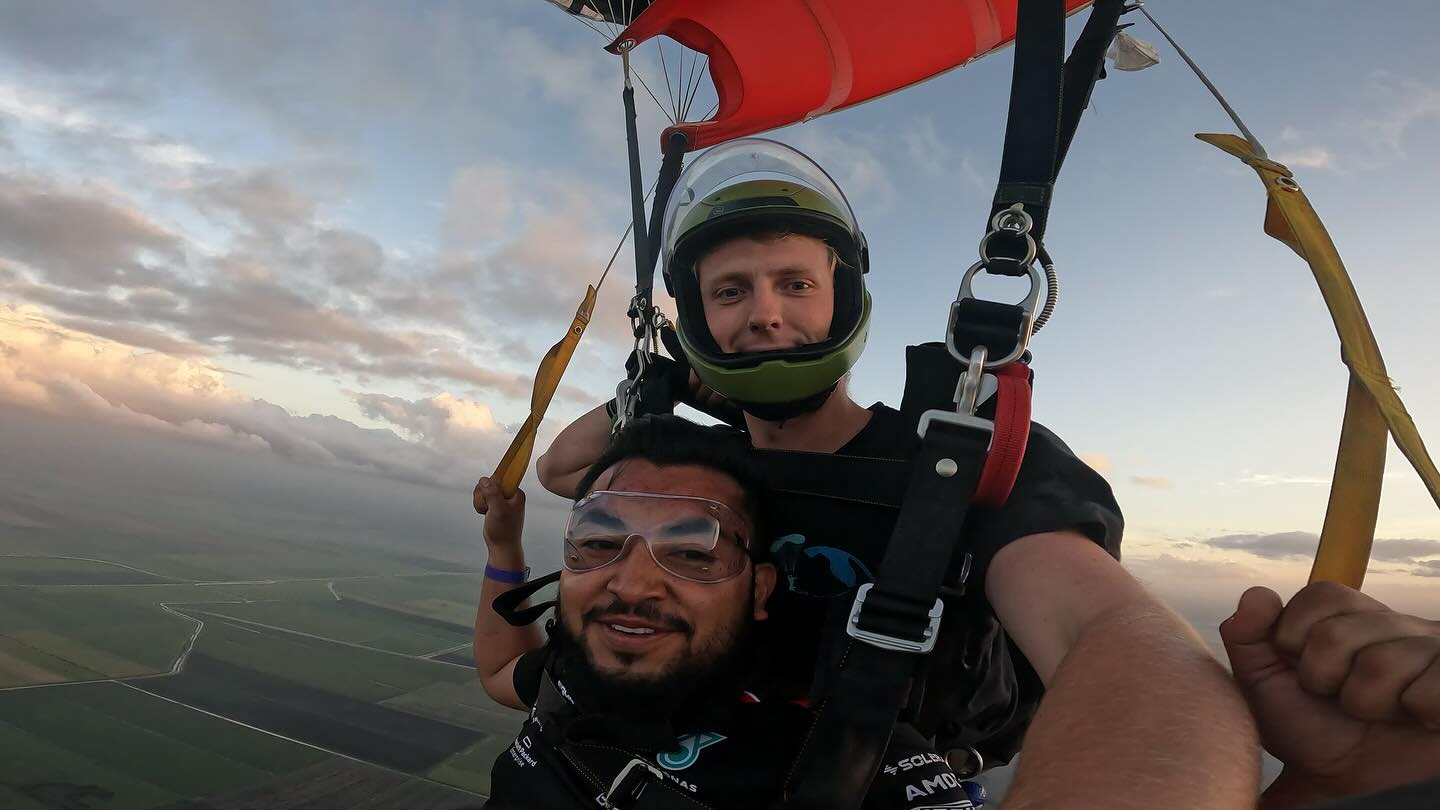 Male tandem skydiver under canopy