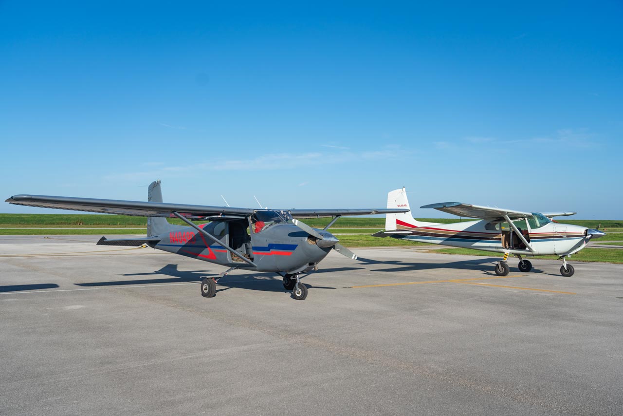 Two Cessna 182 aircraft on the runway at Skydive Palm Beach in South Florida