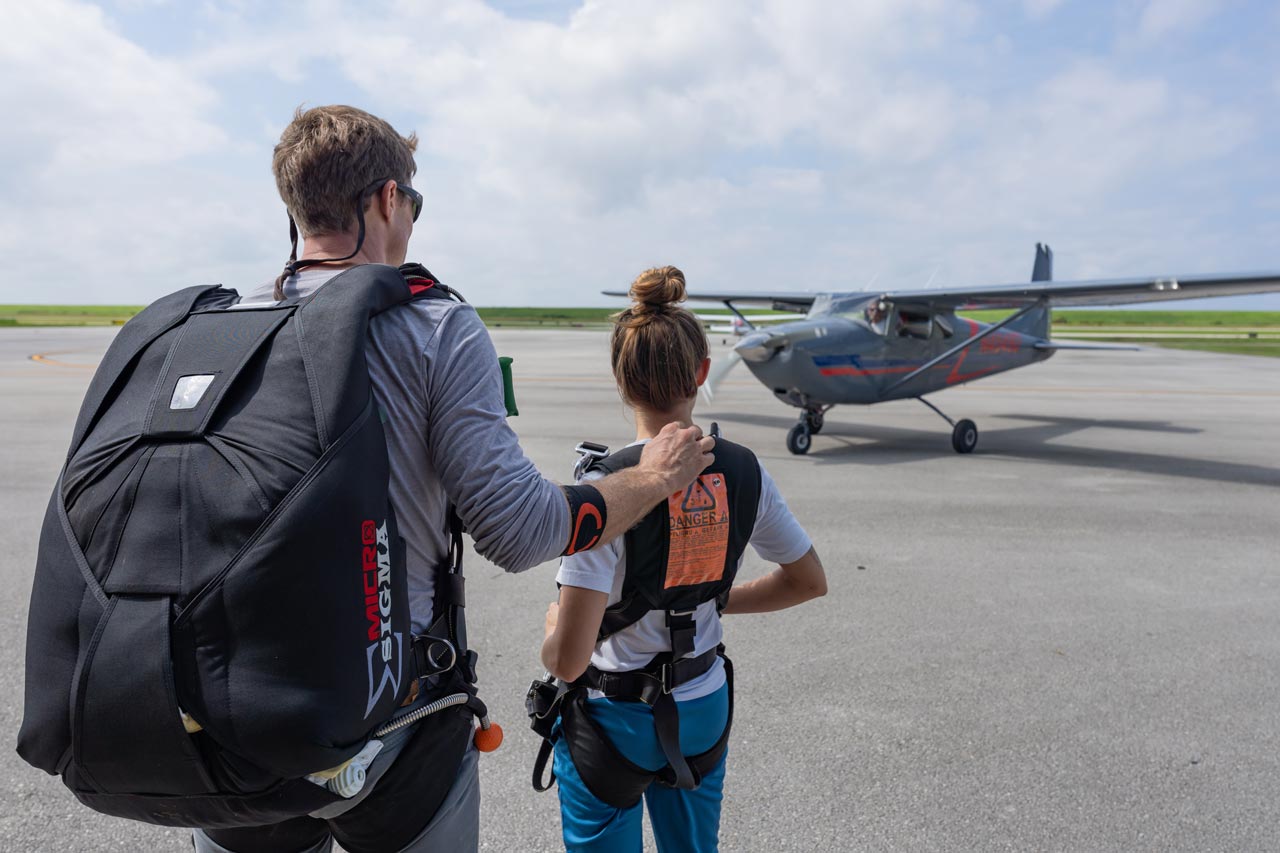Tandem Skydiving instructor and student wait to board an airplane at Skydive Palm Beach in South Florida