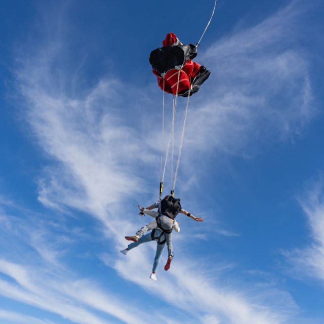 Tandem skydiving student and instructor under canopy at Skydive Palm Beach