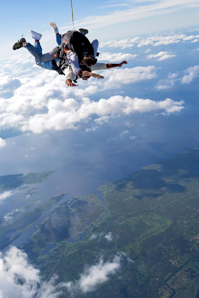 Tandem skydiving student and instructor in freefall over Lake Okeechobee in Florida