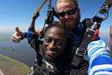 Tandem skydiver with his instructor under canopy