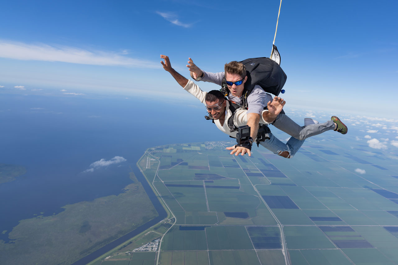 Licensed skydiver and tandem skydiving student in the air