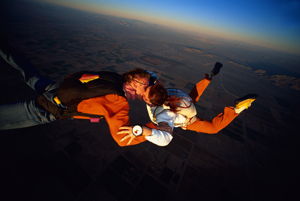 Skydiving couple kissing on mid-air